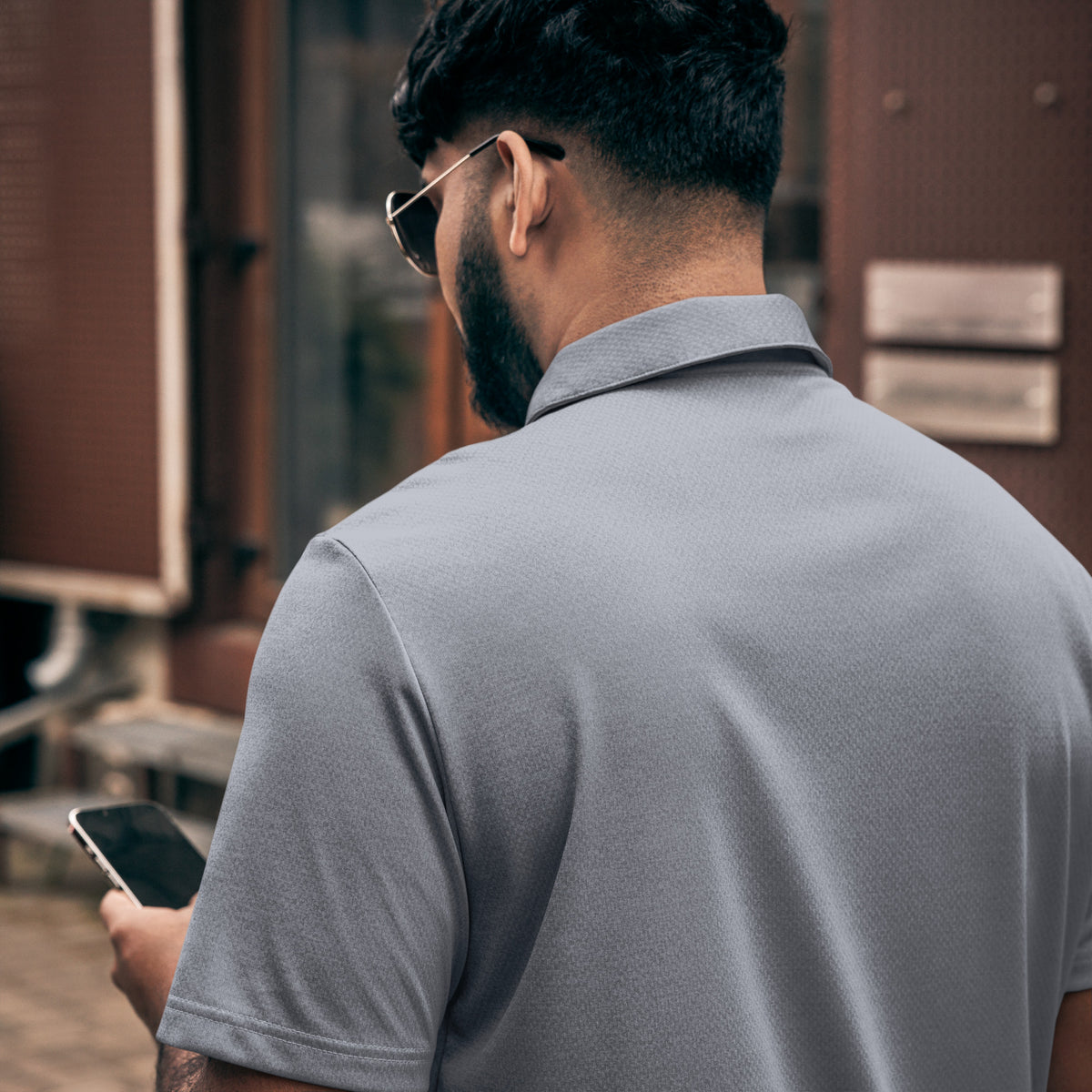 Adidas space-dyed polo shirt in Collegiate Navy Melange, back view